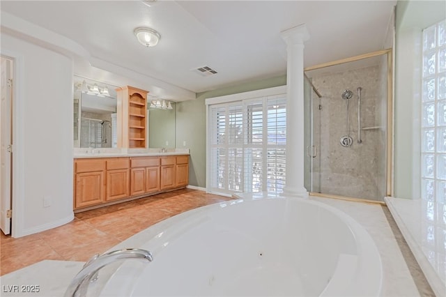 bathroom with a garden tub, visible vents, double vanity, a stall shower, and ornate columns