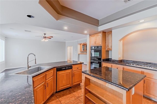 kitchen with dobule oven black, dishwasher, a kitchen island, stainless steel gas stovetop, and a sink