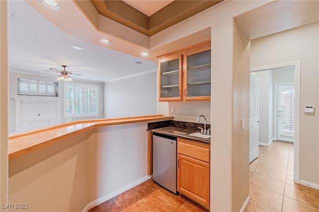 kitchen with crown molding, recessed lighting, stainless steel dishwasher, glass insert cabinets, and a sink