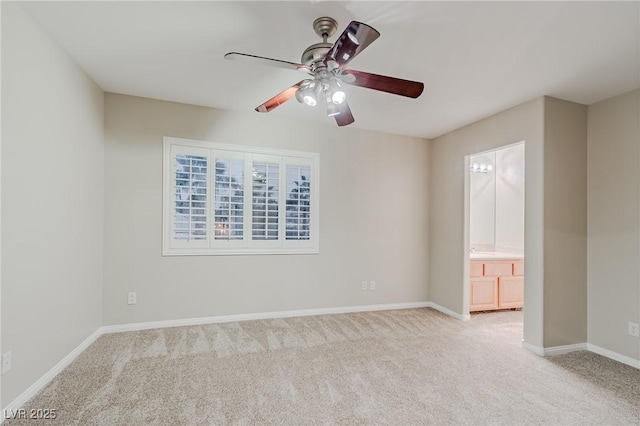 unfurnished room with light carpet, a ceiling fan, and baseboards