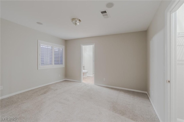 unfurnished room featuring light carpet, visible vents, and baseboards