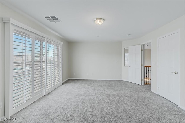 interior space featuring carpet floors, baseboards, and visible vents