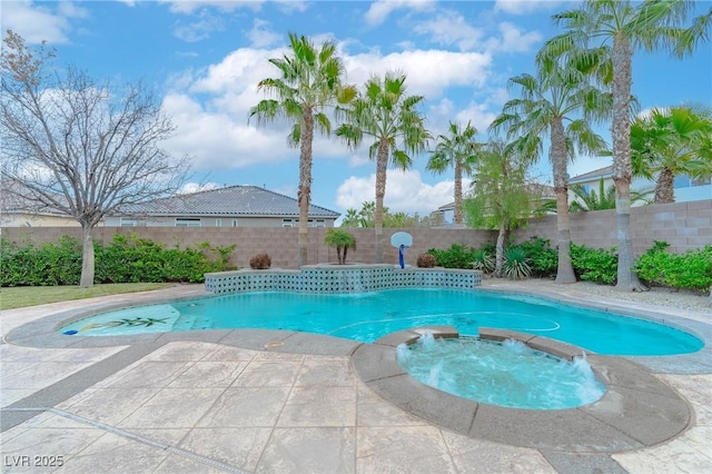 view of swimming pool with a fenced backyard and a pool with connected hot tub