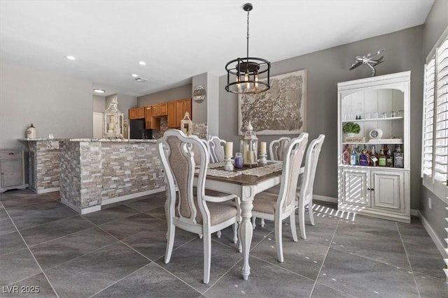 dining room with baseboards, recessed lighting, and an inviting chandelier