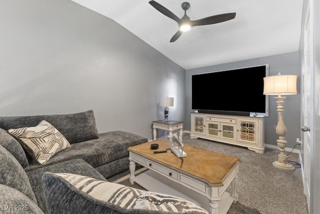 carpeted living area with vaulted ceiling, a ceiling fan, and baseboards