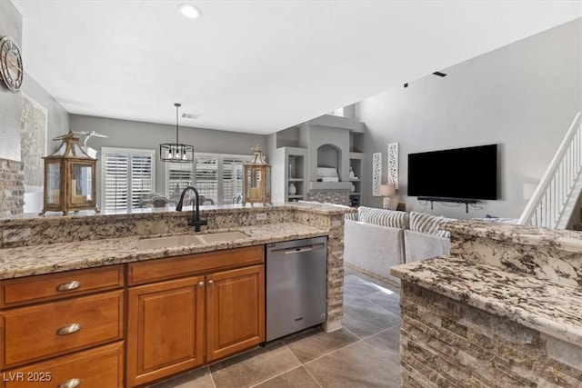 kitchen featuring brown cabinets, visible vents, a sink, light stone countertops, and dishwasher