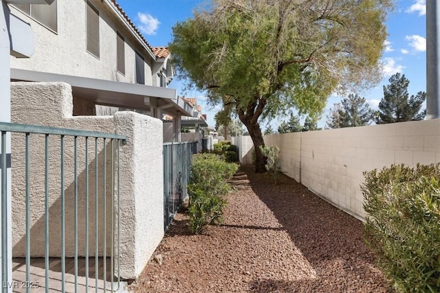 view of yard with a gate and a fenced backyard