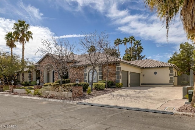 view of front of home featuring a garage, a tile roof, driveway, stone siding, and stucco siding