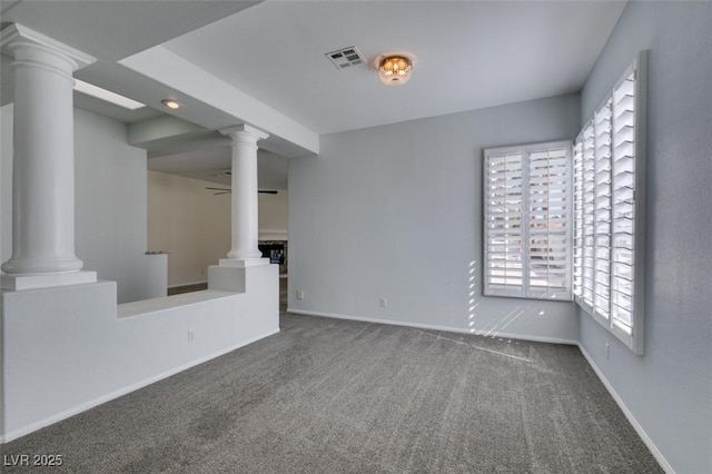 interior space with ornate columns, baseboards, and visible vents