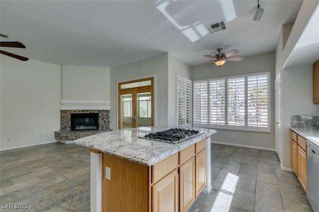 kitchen featuring stainless steel appliances, open floor plan, visible vents, and a ceiling fan