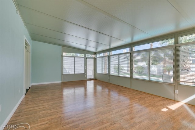 unfurnished sunroom with lofted ceiling