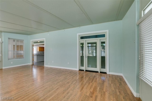 empty room with wood finished floors and baseboards