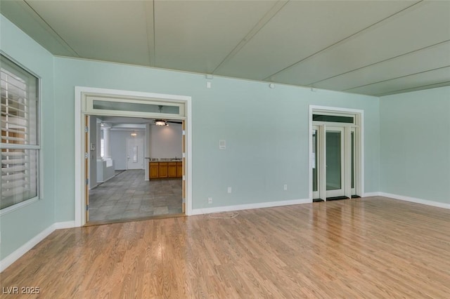 empty room featuring baseboards and wood finished floors