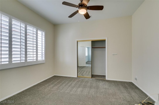 unfurnished bedroom featuring ceiling fan, a closet, baseboards, and carpet flooring