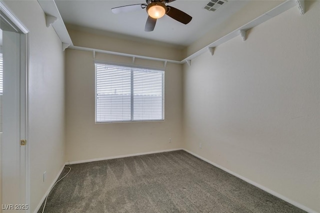 carpeted empty room with visible vents, ceiling fan, and baseboards