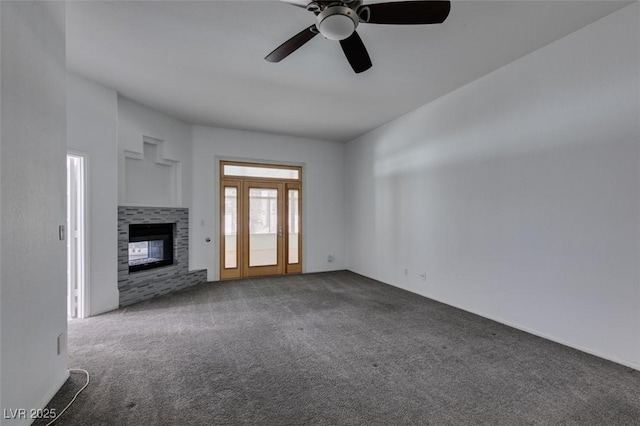 unfurnished living room with ceiling fan, carpet, and a multi sided fireplace