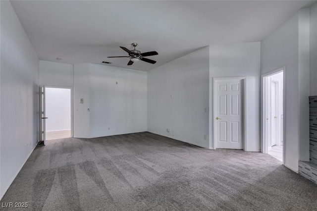 carpeted empty room featuring visible vents and a ceiling fan