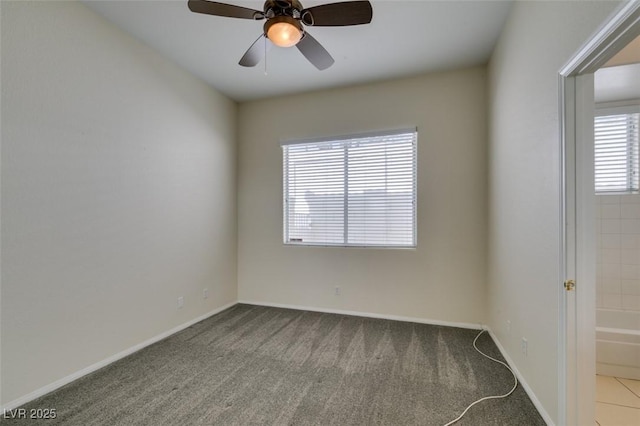 unfurnished room featuring carpet floors, baseboards, and a ceiling fan