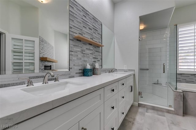 bathroom featuring double vanity, tasteful backsplash, a sink, and a shower stall