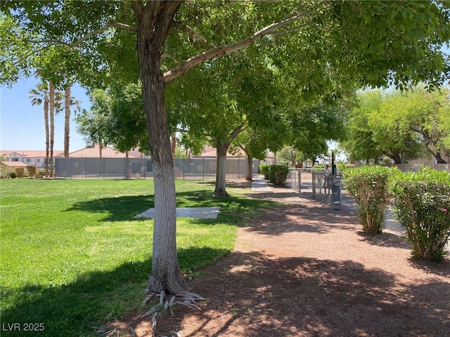 view of community featuring fence and a lawn