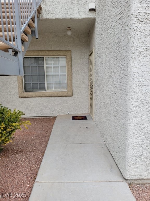 view of exterior entry with stucco siding