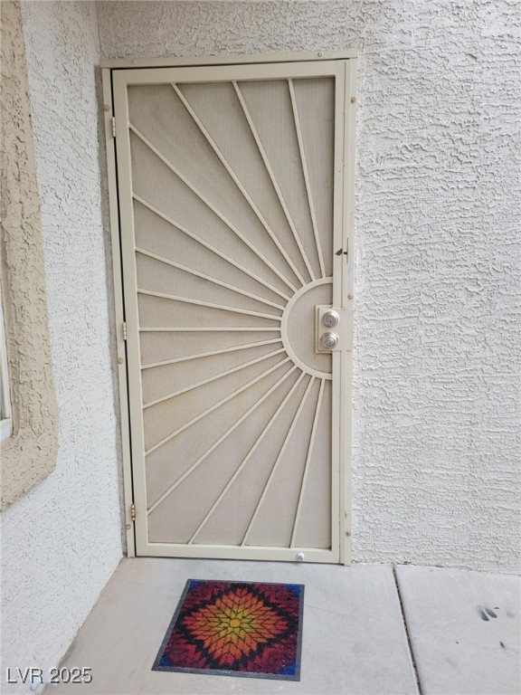 property entrance featuring stucco siding