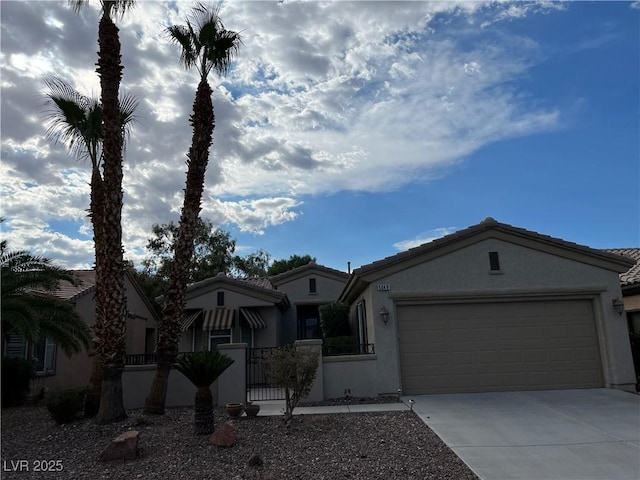 view of front of property with a garage, driveway, a fenced front yard, a gate, and stucco siding