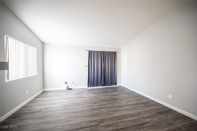 unfurnished room with baseboards and wood finished floors