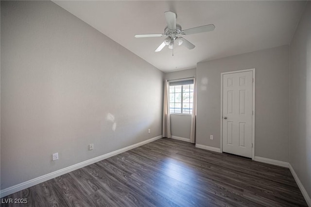 unfurnished room with a ceiling fan, dark wood finished floors, and baseboards