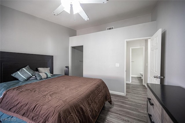 bedroom with dark wood-style flooring, visible vents, ceiling fan, and baseboards