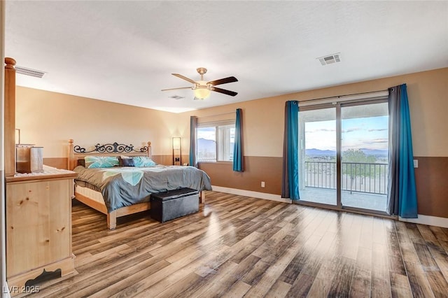 bedroom featuring ceiling fan, visible vents, wood finished floors, and access to outside