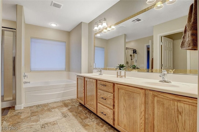 bathroom featuring a shower stall, a bath, visible vents, and a sink