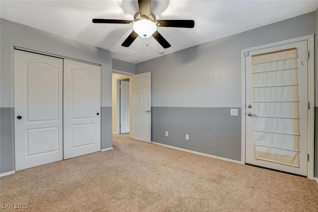 unfurnished bedroom featuring ceiling fan, carpet, a closet, and baseboards