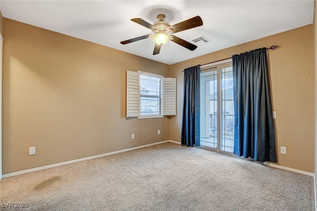 unfurnished room with visible vents, a ceiling fan, baseboards, and carpet floors