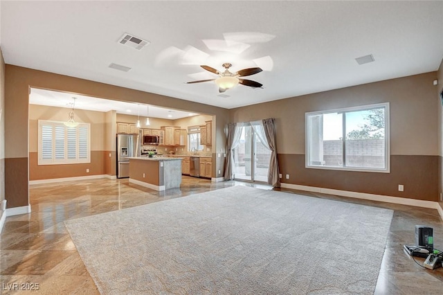 kitchen with visible vents, a center island, open floor plan, and stainless steel appliances