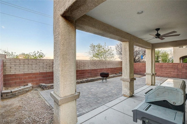 view of patio / terrace featuring ceiling fan, a grill, and a fenced backyard