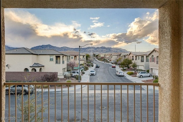 exterior space featuring a mountain view, a residential view, and street lights