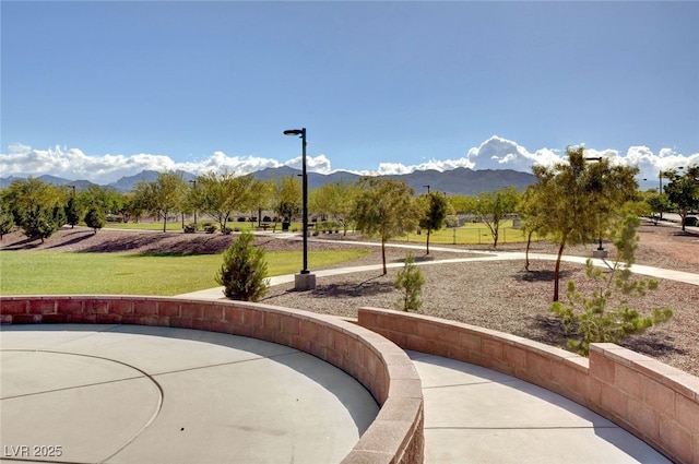 view of property's community with a mountain view and a yard