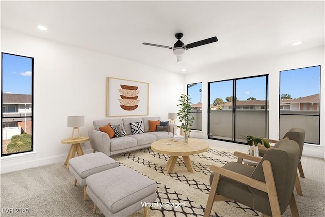 living area featuring light carpet, plenty of natural light, and recessed lighting