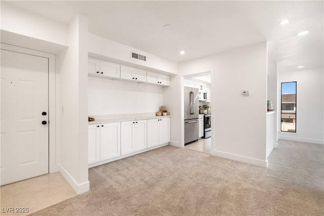 mudroom featuring recessed lighting, visible vents, baseboards, and light colored carpet