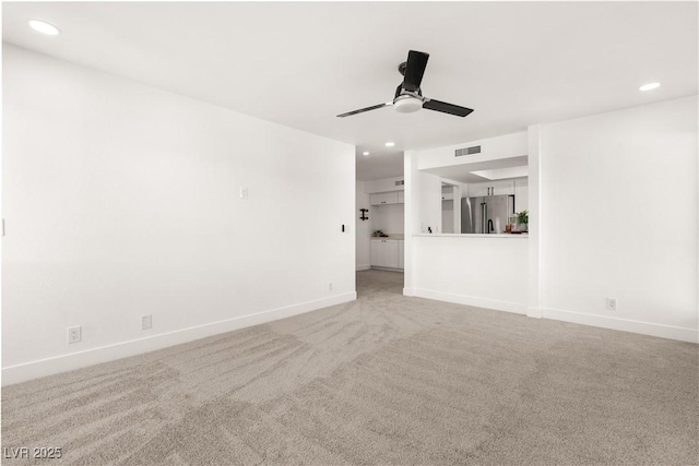 unfurnished living room with visible vents, baseboards, light colored carpet, ceiling fan, and recessed lighting