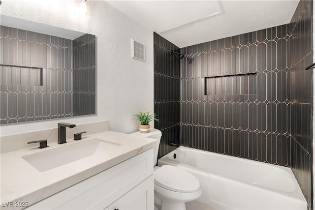 full bath featuring shower / bath combination, visible vents, a textured wall, toilet, and vanity