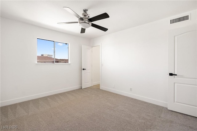 empty room featuring visible vents, ceiling fan, light carpet, and baseboards