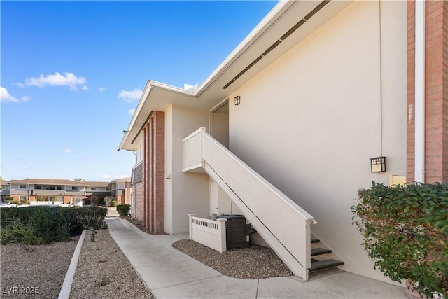 view of property exterior with stairway and stucco siding