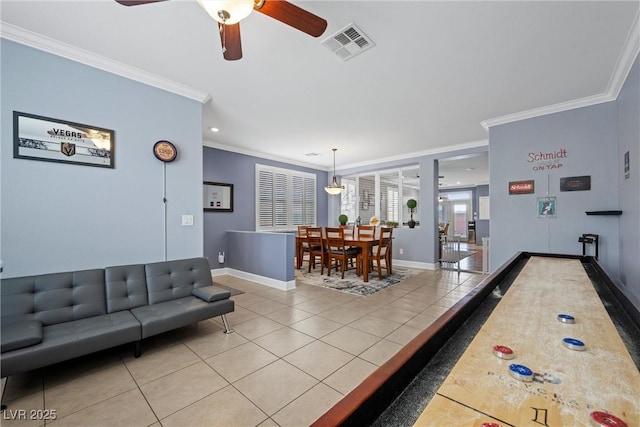 living room with baseboards, visible vents, crown molding, and light tile patterned flooring