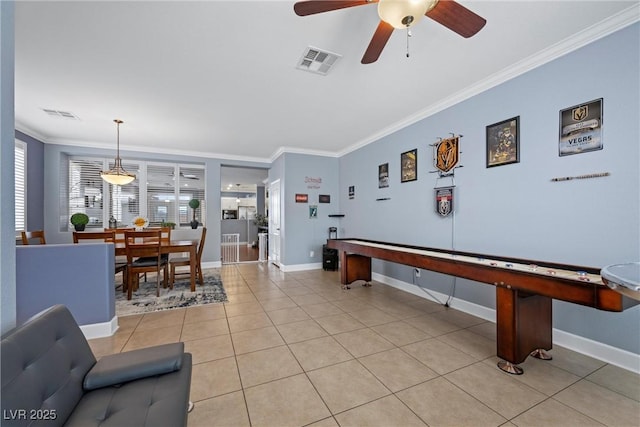 game room with light tile patterned floors, baseboards, visible vents, and crown molding