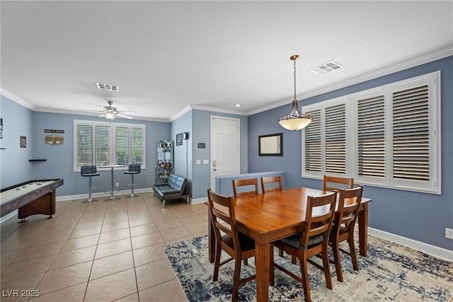 dining space with light tile patterned floors, baseboards, visible vents, and crown molding