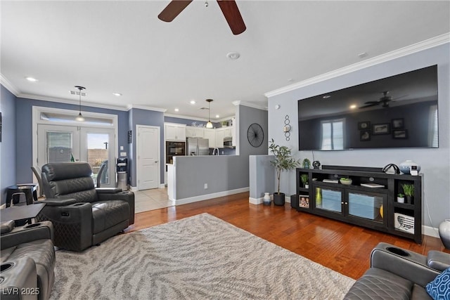 living room featuring ornamental molding, french doors, wood finished floors, and baseboards