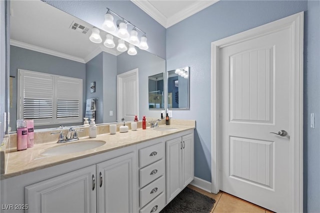 bathroom featuring ornamental molding, visible vents, and a sink