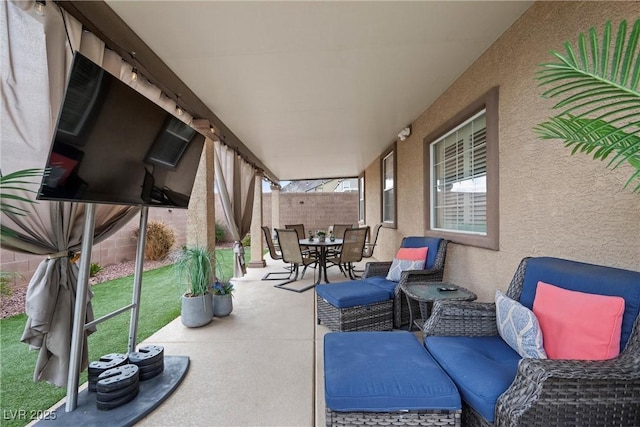 view of patio featuring outdoor dining area, a fenced backyard, and an outdoor living space